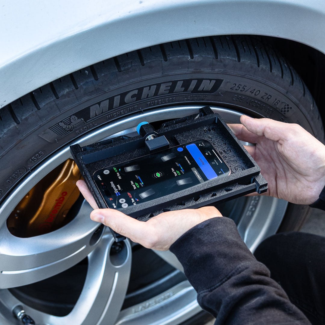 Person using a digital tool on a Michelin tire