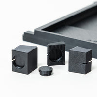Black 3D-printed geometric shapes on a white background